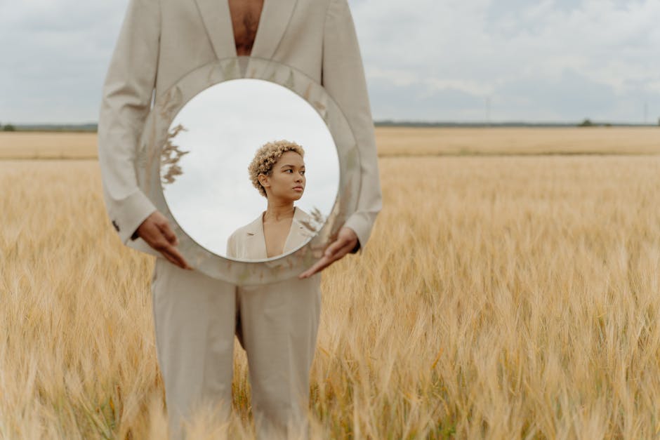 pexels-photo-10679199-10679199-1 A creative portrait using a mirror in a wheat field capturing reflection art and natural beauty.